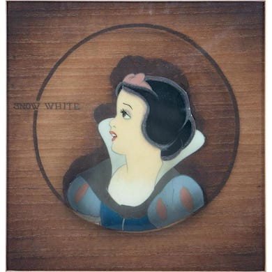 Original animation cel from ‘Snow White and the Seven Dwarfs,’ mounted on a woodgrain background, estimated at $1,000-$1,500