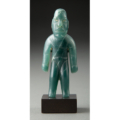 Olmec standing figure, carved in blue-green jade and estimated at $75,000-$100,000
