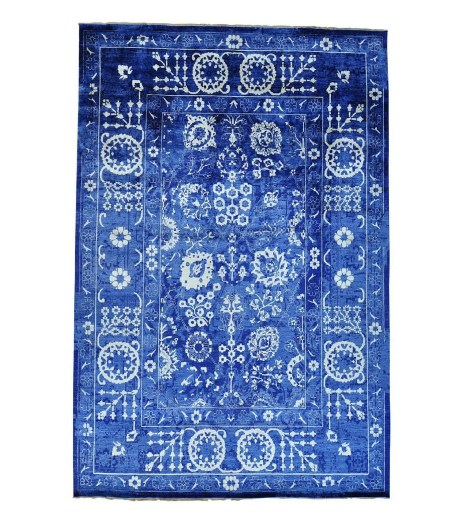  Oversize rug in luxurious shades of blue and white, estimated at $8,000-$10,000