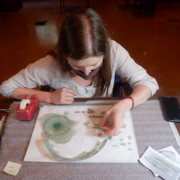 Conservator Claire Cuyaubere assisting with "puzzle-work" on a shard from a glass dish at the Archaeological Museum, AUB. Courtesy of the AUB Office of Communications and Archaeological Museum