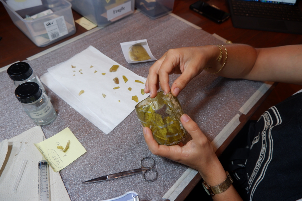 Completing "puzzle-work" of a smashed glass beaker at the Archaeological Museum, AUB. Courtesy of the AUB Office of Communications and Archaeological Museum
