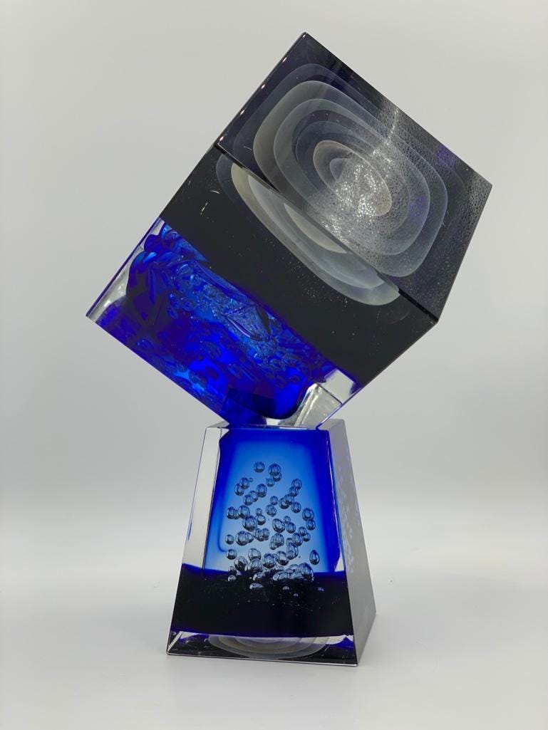 Stefano Toso Murano blown glass sculpture in the form of a cube balancing on a pyramidial base, estimated at $1,200-$2,000