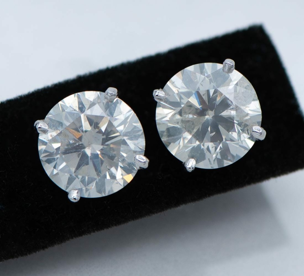 Pair of diamond solitaire stud earrings, est. $30,000-$50,000
