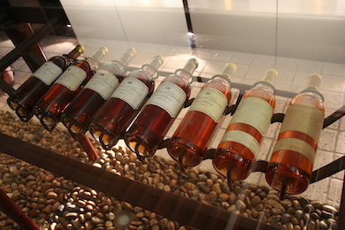A September 2010 image of a rack of Chateau d’Yquem dessert wines, taken to show how the wine changes color as it ages. In late October 2021, a bottle of the 1806 vintage, valued at $407,000, was stolen from the cellar of a two-Michelin-star restaurant in Caceres, Spain. Image courtesy of Wikimedia Commons, credited to Megan Mallen and licensed under the Creative Commons Attribution 2.0 Generic license.
