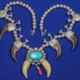 Hollow silver bead necklace with six bear claws capped with silver adornments, plus a central turquoise cabochon, $1,562