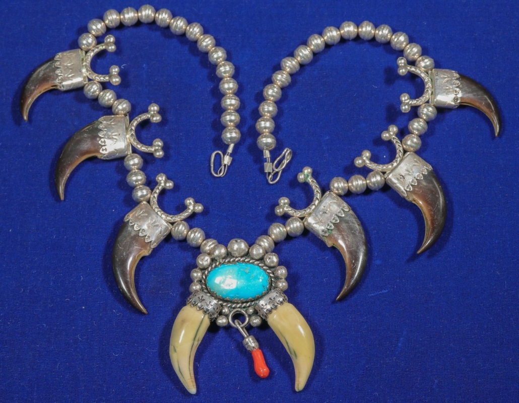 Hollow silver bead necklace with six bear claws capped with silver adornments, plus a central turquoise cabochon, $1,562