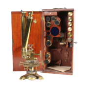 Cased Spencer Lens Company brass microscope with objective lenses and additional attachments, est. $300-$500