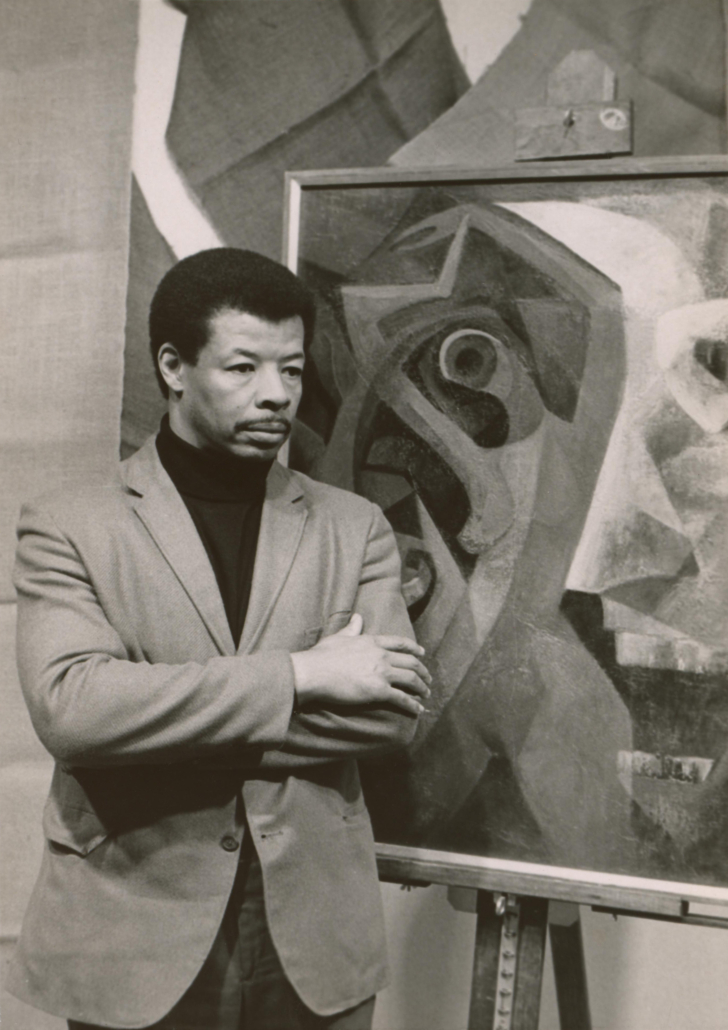Percy Ricks with painting, circa 1970, taken by an unknown photographer. Courtesy of the Delaware Art Museum