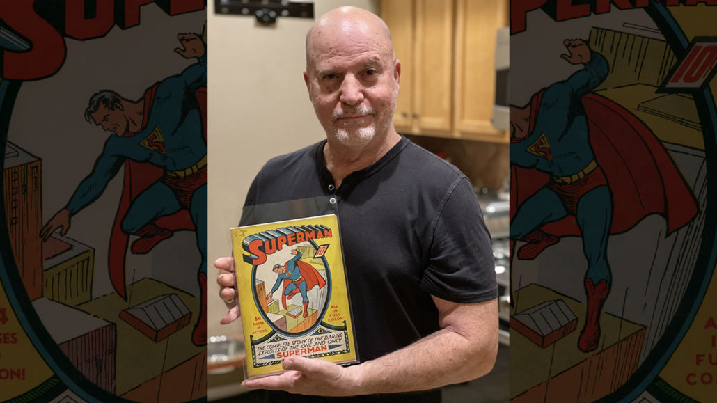 Consignor Mark Michaelson holds the copy of Superman #1 that later sold for $2.6 million. Image courtesy of ComicConnect.com