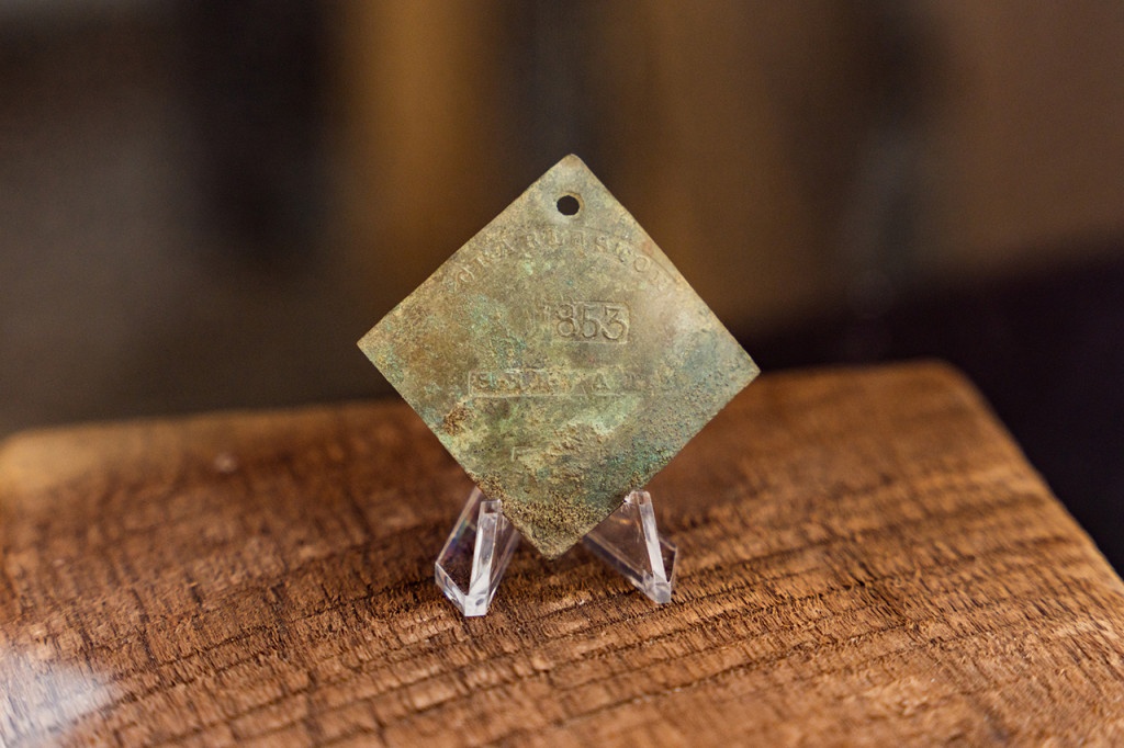 A copper slave badge found on the site of a 19th-century kitchen in Charleston, S.C., has been named one of the world’s top 2021 discoveries by Archaeology Magazine. Image courtesy of the College of Charleston
