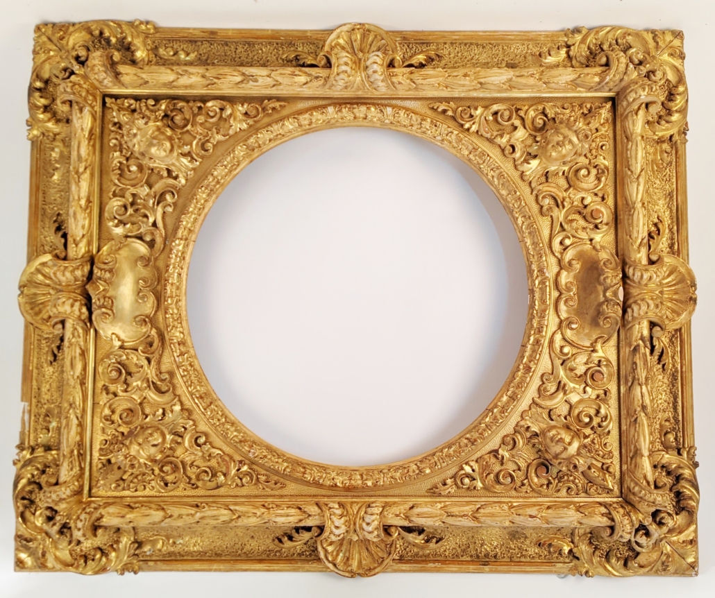 Large, ornately carved figural wooden frame, est. $1,000-$1,500