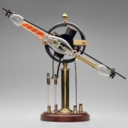 Geissler tube rotator [with modern tube], late 19th century. James W. Queen & Company, Philadelphia, brass, mahogany, lacquer, glass, resin, iron, wire. Courtesy of Mark McElyea. L2021.1301.004a–b