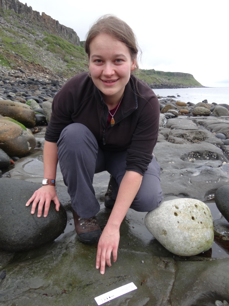 PhD student Amelia Penny pictured with the pterosaur at the site where she discovered it on the Isle of Skye in Scotland. Image courtesy of the National Museum of Scotland.
