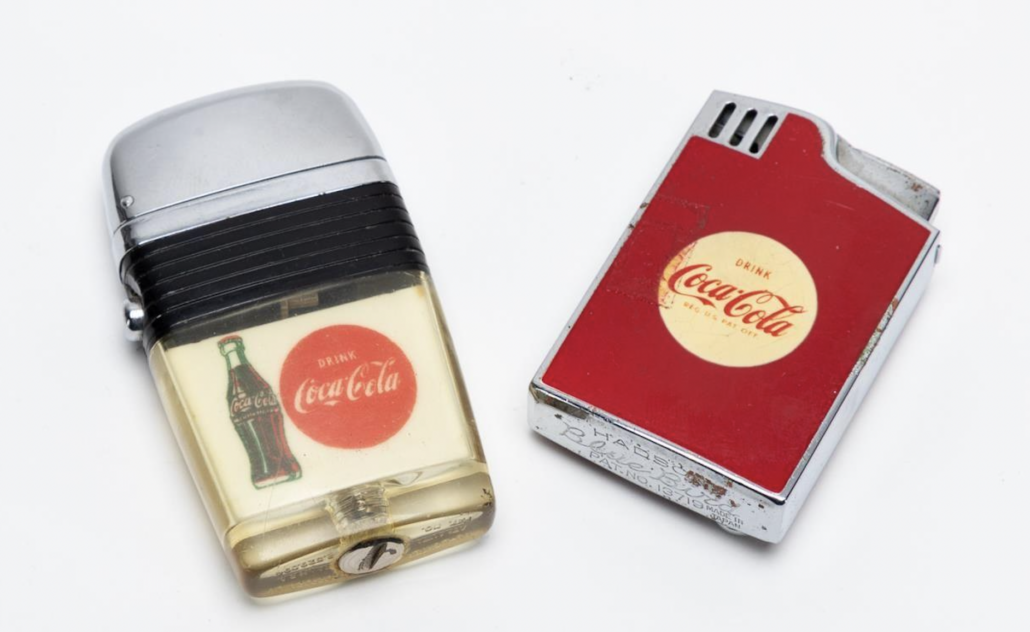 Two of Robert Woodruff’s personal Coca-Cola advertising lighters, $3,438