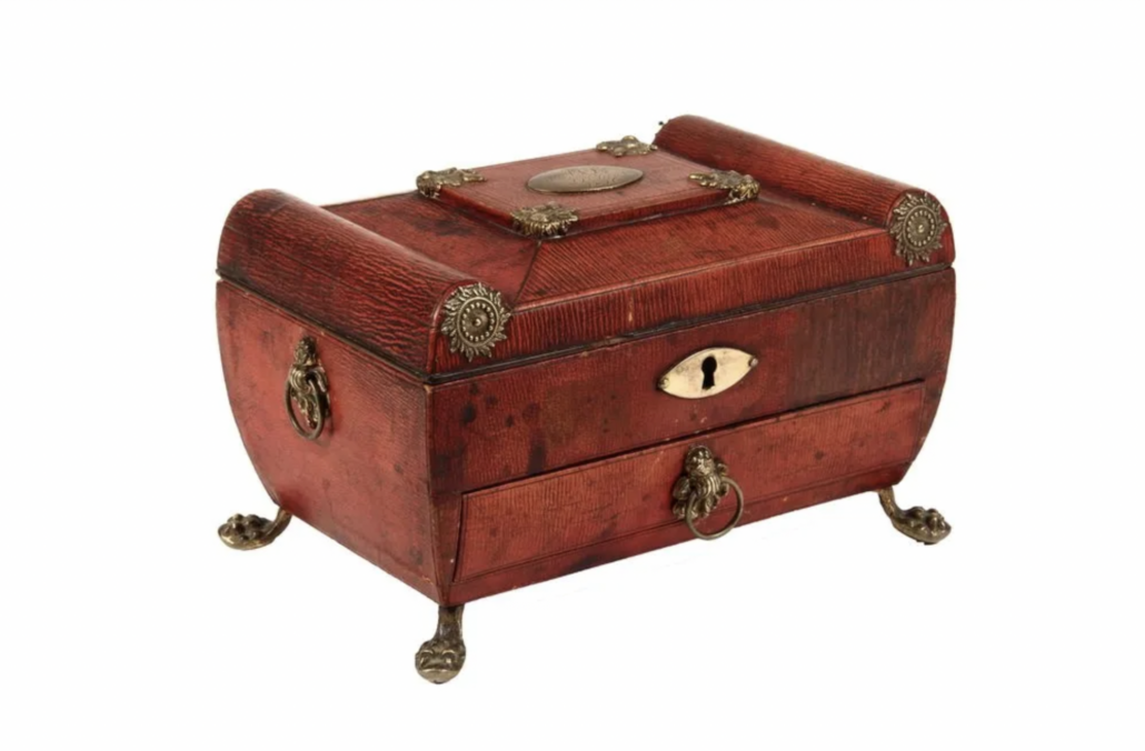 An English Regency casket-form sewing box, decorated with embossed red leather, gilt brass fittings and lion paw feet, sold for $650 plus the buyer’s premium in November 2014. Image courtesy of Thomaston Place Auction Galleries and LiveAuctioneers.