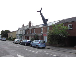 An Oxford, England house with a sculpture of a shark sticking out of its roof has received protected landmark status, to the dismay of the home’s owner. Image courtesy of Wikimedia Commons. Attribution: The shark at Headington by Gareth James. Shared under the Creative Commons Attribution-Share Alike 2.0 Generic license.