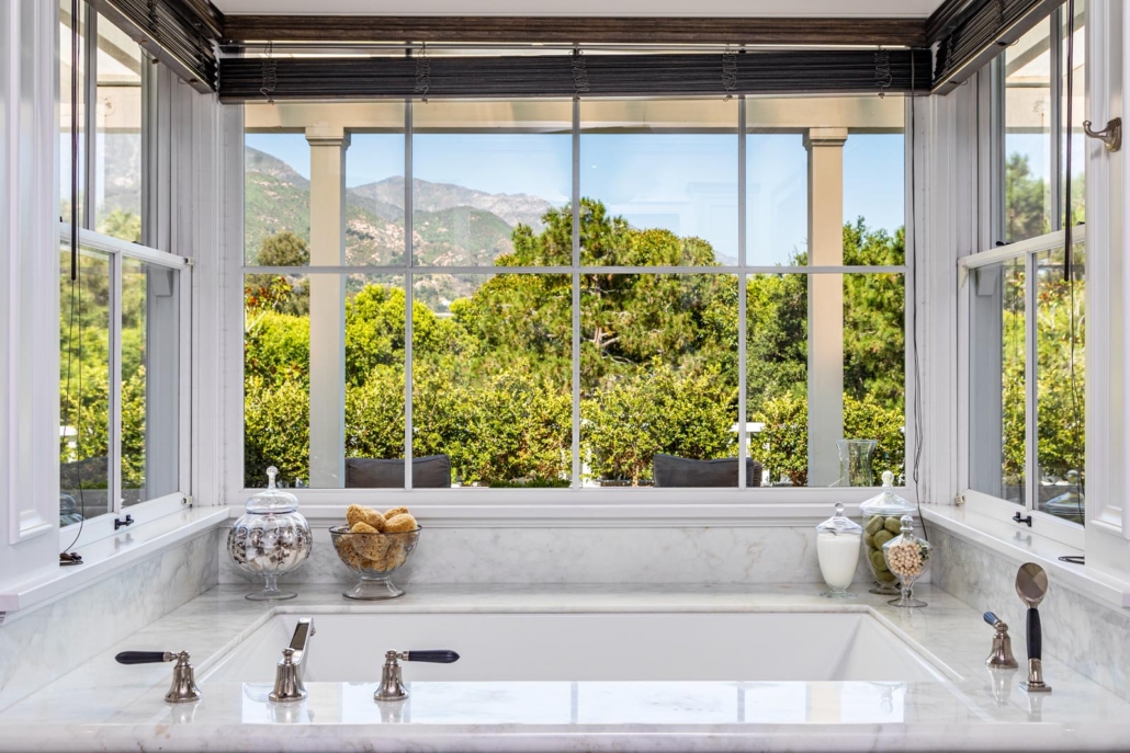One of the Montecito home’s six bathrooms delivers dramatic views along with a soothing soak. Photo credit: The Agency 2019. Courtesy of TopTenRealEstateDeals.com
