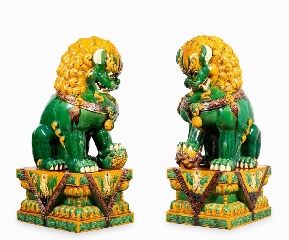Monumental pair of Chinese Sancai glaze ceramic seated Buddhist lion figures on stands, $5,938