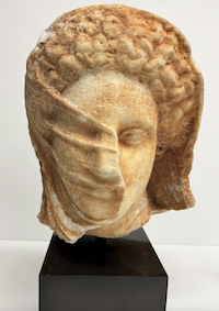 US authorities have returned a cache of looted antiquities to Libya, among them a Hellenic bust of a veiled woman dating to circa 350 BCE. Image courtesy of the Manhattan District Attorney’s Office.