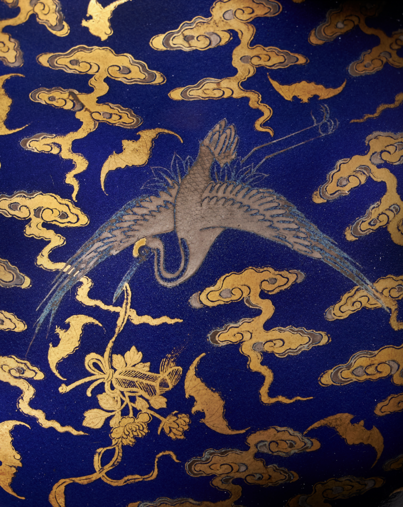 The Qianlong-era vase features decorations of silver and gold against a blue ground.