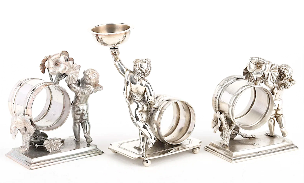 A grouping of Cupid napkin rings, three of which are shown here, earned $2,338 plus the buyer’s premium in May 2022. Image courtesy of Miller & Miller Auction Ltd. and LiveAuctioneers.