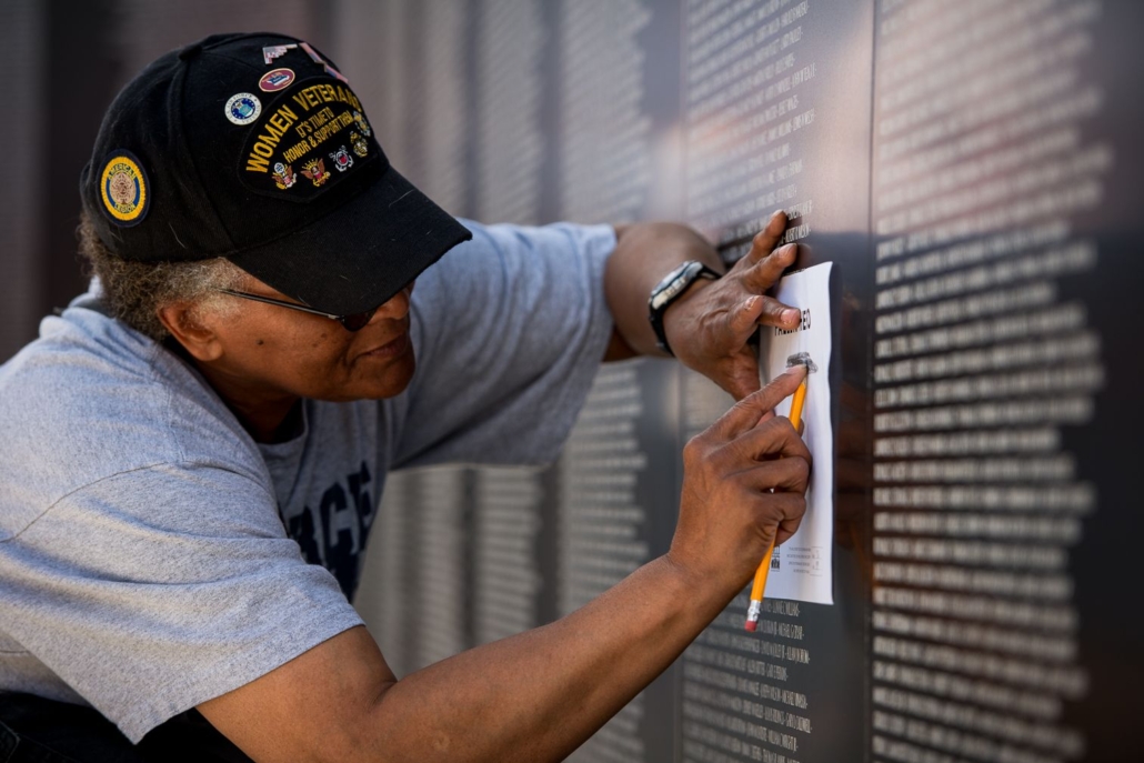 A veteran takes an impression of a name etched on the American Veterans Traveling Tribute (AVTT) Vietnam Wall, which will be displayed at the National WWI Museum and Memorial during Memorial Day Weekend 2022. Image courtesy of the National WWI Museum and Memorial