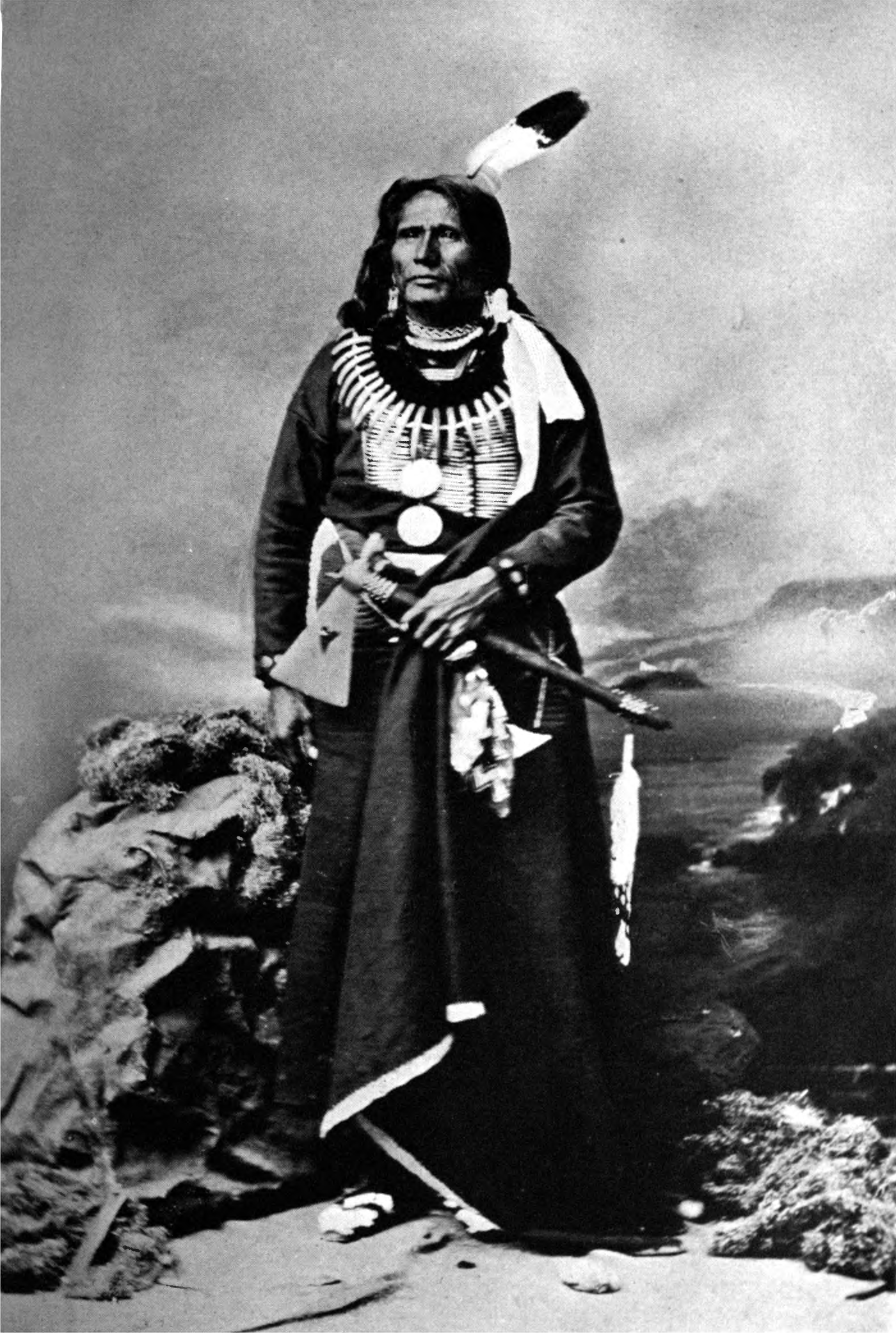 Chief Standing Bear photographed in 1877, apparently holding the pipe-tomahawk he would give to one of his lawyers two years later. The object was acquired by Harvard University in 1982, and on June 3, the institution and its relevant museum returned it to the Ponca tribe. Courtesy of Wikimedia Commons, which states that the image, extracted from the 1906 book The Indian Dispossessed, is in the public domain in the United States because it was published prior to January 1, 1927, and/or the copyright was, for whatever reason, not renewed.
