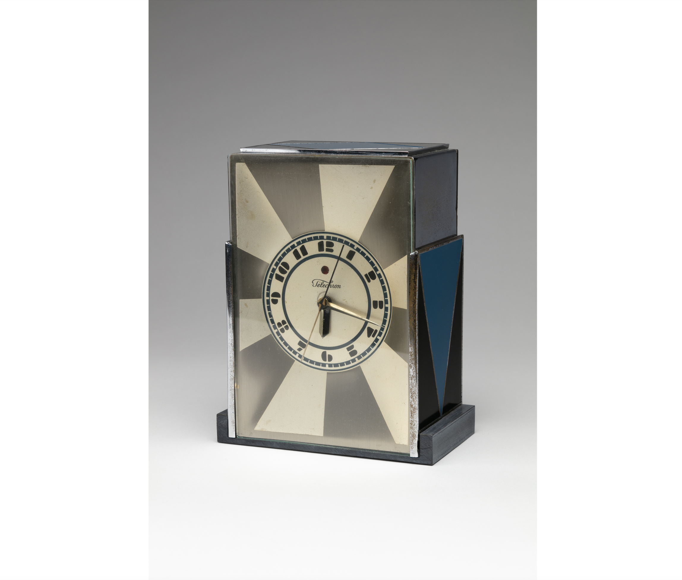 Modernique clock, 1928, chromiun-plated and enameled metal, molded Bakelite and brush-burnished silver. Paul T. Frankl, designer, American, born Austria, 1887-1958. Warren Telechron Company, manufacturer, Ashland, Massachusetts, 1926-1992. 7 3/4 by 6 by 3 1/2in. Collection Kirkland Museum of Fine & Decorative Art, Denver, gift of Michael Merson, 2010.0670. Courtesy of Kirkland Museum of Fine & Decorative Art, Denver. Photo by Wes Magyar