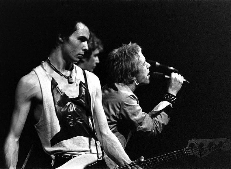 The Sex Pistols (left to right: Sid Vicious, Steve Jones, and Johnny Rotten) on stage in Trondheim, Norway on July 21, 1977. The legendary punk band’s anthem, ‘God Save the Queen,’ which debuted during Queen Elizabeth II’s Silver Jubilee, has been re-released to mark the British monarch’s Platinum Jubilee. Image courtesy of Wikimedia Commons, photo credit Riksarkivet (National Archives of Norway), Belledbladet NA Arne S. Nielsen. It was taken from Flickr’s The Commons, which determined that no known copyright restrictions apply.
