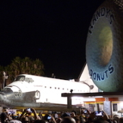 The Space Shuttle Endeavour pictured with the Los Angeles landmark Randy’s Donuts as the retired spaceship proceeded to the California Science Center on October 12, 2012. Ground was broken for a new museum devoted to Endeavour on June 1. Image courtesy of Wikimedia Commons, photo credit Bluesnote. Shared under the Creative Commons Attribution-Share Alike 3.0 Unported license