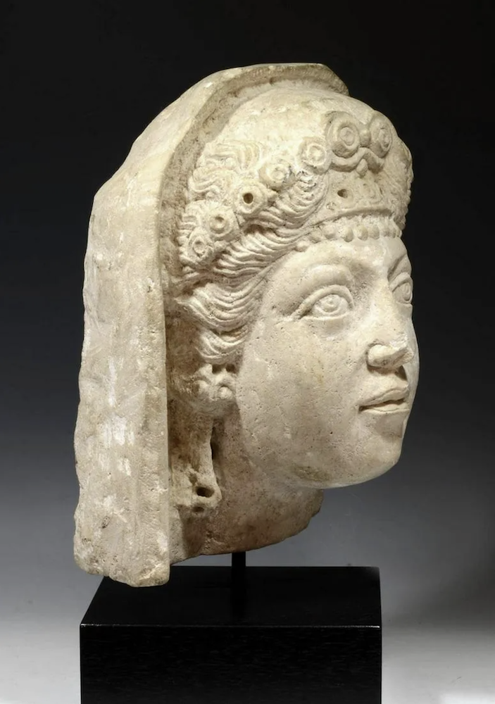 Circa-1st/2nd century CE, Roman Imperial period, Palmyra, hand-carved limestone head of a veiled woman, perhaps intended as a funerary portrait. Size: 13in high. Provenance: New York, NY private collection; Florida philanthropist J.I.K. collection, acquired 1970s/1980s. Est. $36,000-$54,000. Courtesy of Artemis Gallery