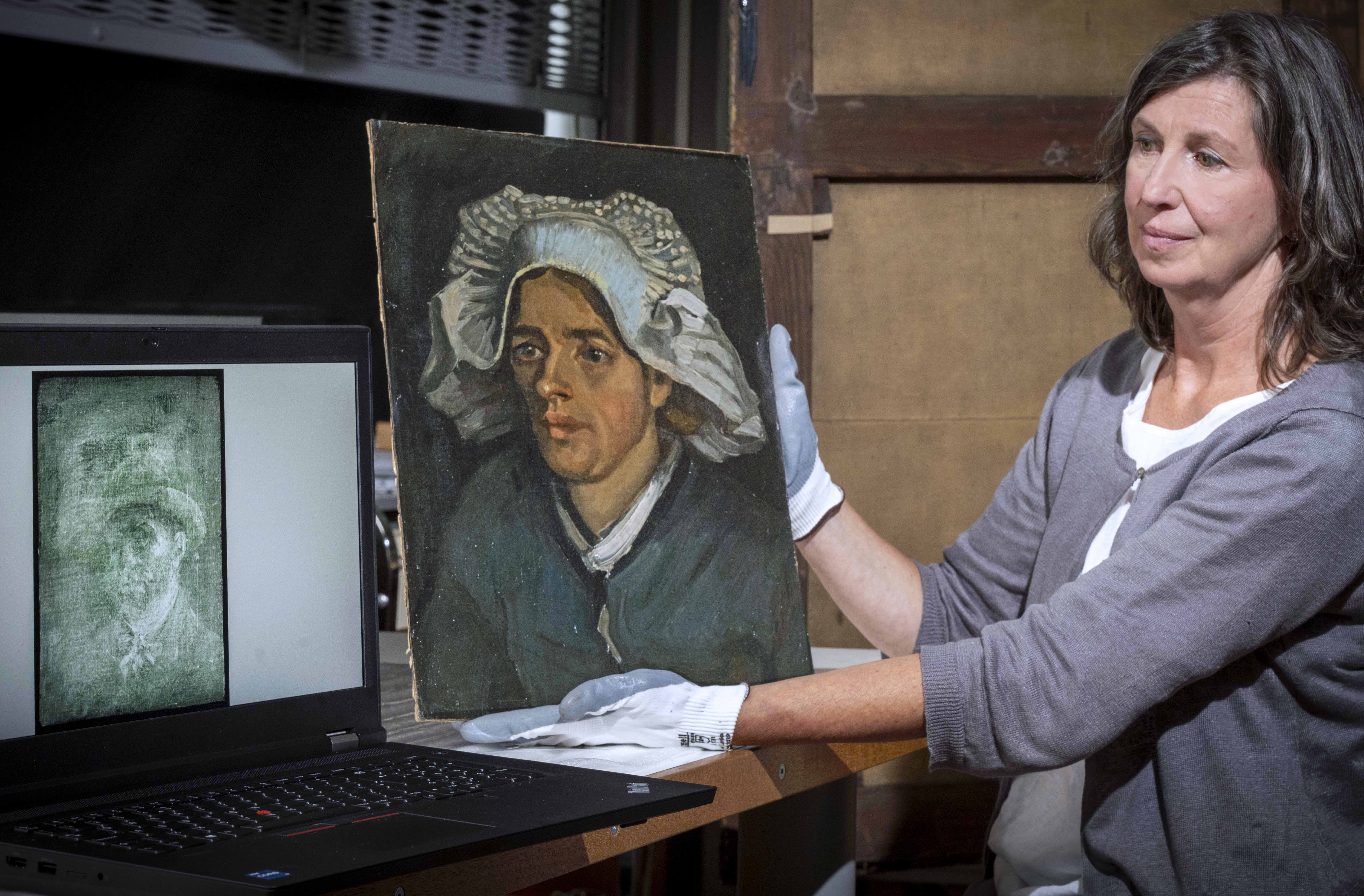 Senior Conservator Lesley Stevenson views ‘Head of a Peasant Woman’ alongside an X-ray image of the hidden Van Gogh self-portrait. Photograph by Neil Hanna. Courtesy of the National Galleries of Scotland