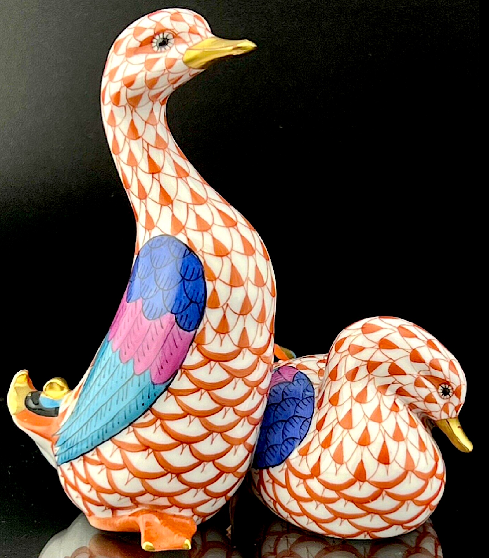 Pair of porcelain Herend ducks painted with a rust fishnet motif, est. $1,000-$5,000