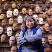 Ruth Asawa with life masks on the exterior wall of her house. Photography by Terry Schmitt. Artwork: ‘Untitled (LC.012, Wall of Masks),’ circa 1966–2000. Ceramic, bisque-fired clay. © 2022 Ruth Asawa Lanier, Inc. / Artists Rights Society (ARS), New York. Courtesy David Zwirner