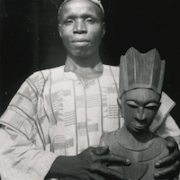 E. H. Duckworth, ‘Moshood Oluṣọmo Bamigboye Holding a Portrait Bust.’ Ilọfa, Kwara State, Nigeria, circa 1940. Danford Collection of West African Art and Artefacts, University of Birmingham, United Kingdom, inv. no. birrc-d432-1. © Research and Cultural Collections, University of Birmingham