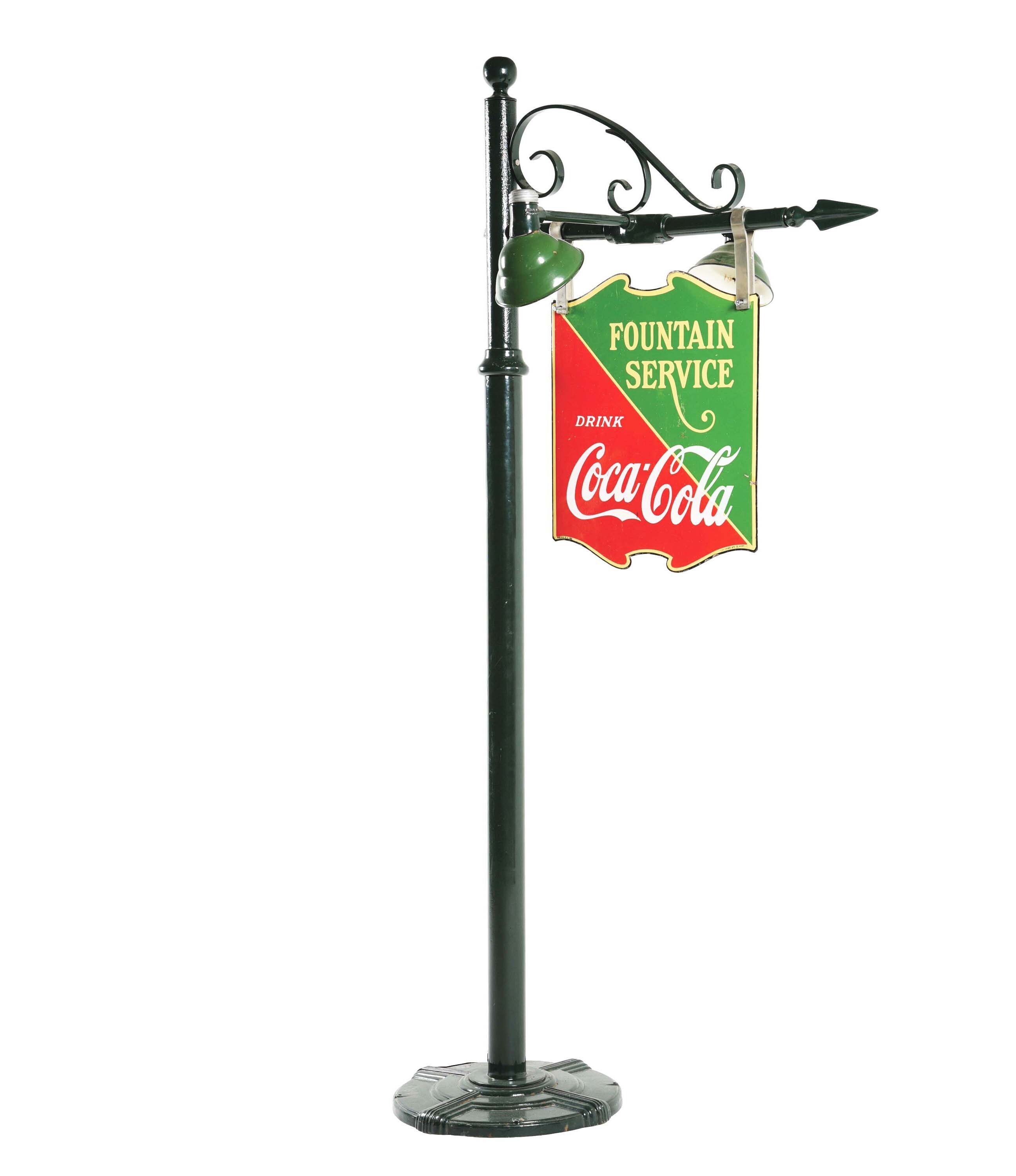 Double-sided die-cut porcelain Fountain Service Coca-Cola hanging sign with lighted cast-iron floor stand. Marked ‘Tenn. Enamel Mfg. Co. Nashville’ and ‘Made in U.S.A. 1933.’ Size: 94 x 40 x 34in. Outstanding color and gloss. Estimate $2,000-$3,000
