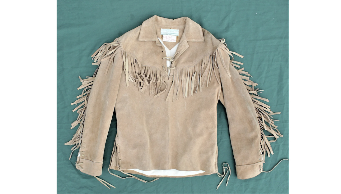 Fringed buckskin jacket worn by John Wayne in the film ‘The Alamo.’ Collar tags from both United Costumers and Wayne’s production company, Batjac, identifying the film and actor. Accompanied by Boyd Magers LOA, affidavit, and portfolio of information. Est. $8,000-$15,000