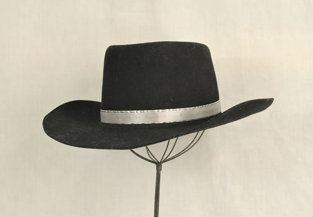 Silver-banded black hat worn by John Wayne in the film ‘Red River,’ as seen in movie studio publicity hand-out photo. Described by ‘Entertainment Magazine’ as one of the most iconic hats in film history. Extensive documentation includes Boyd Magers LOA, and signed affidavit. Est. $10,000-$30,000