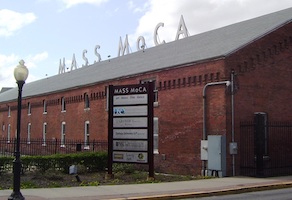 Exterior of the Massachusetts Museum of Contemporary Art, aka MASS MoCA, photographed in April 2012. Unionized workers at the North Adams, Mass., museum have announced a one-day strike to take place on Friday, August 19. Image courtesy of WikiMedia Commons, photo credit Beyond My Ken. Shared under a series of Creative Commons licenses, most recently the Creative Commons Attribution-Share Alike 4.0 International license.