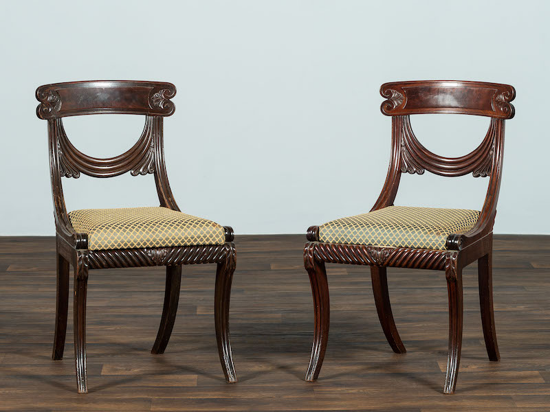 Pair of 19th-century classical drapery carved mahogany side chairs, $28,125