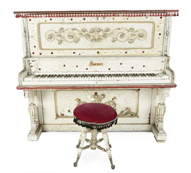 A circa-1902 Howard Cabinet Grand J upright piano customized for and played on stage by Liberace earned $30,000 plus the buyer’s premium in June 2020. Image courtesy of Julien’s Auctions and LiveAuctioneers.