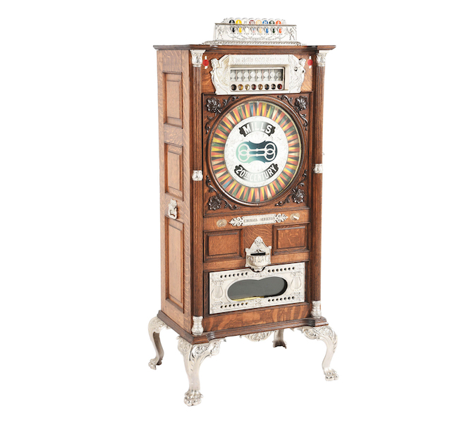 Mills Novelty Co., musical upright slot machine with eight-way coin head, manufactured between 1900-1902. Beautiful dark-stained quarter-swan oak cabinet with carved details and decorative nickel-plated iron castings throughout. Estimate $12,000-$24,000. Courtesy of Morphy Auctions