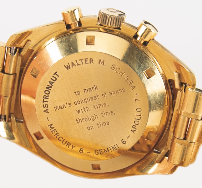 Detail of gold Omega Speedmaster Professional watch presented to astronaut Wally Schirra, showing the inscription on the back of the case