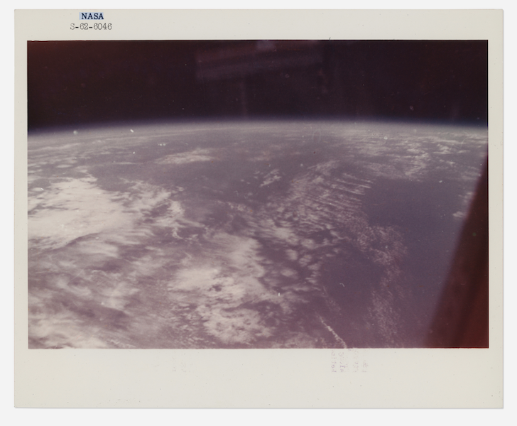 First photograph taken from space by man: Blue Earth horizon and black sky of space from Friendship 7, John Glenn, Mercury Atlas 6, February 20, 1962, estimated at $5,000-$7,000