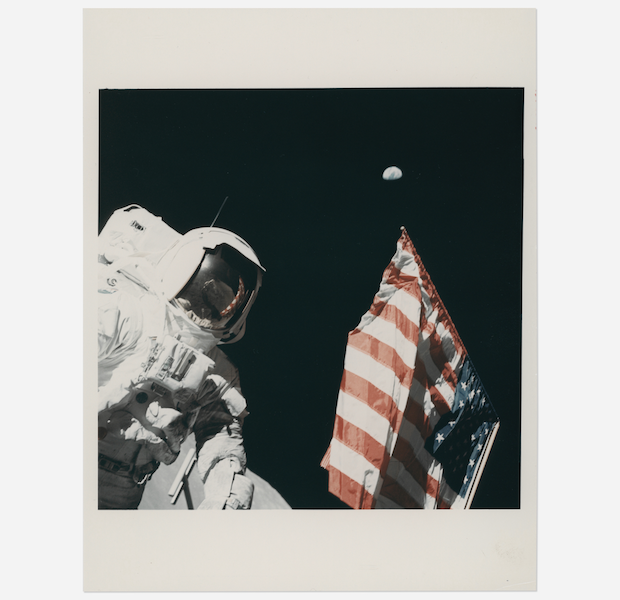 Harrison Schmitt, the Earth and the US flag, Eugene Cernan, Apollo 17, December 7-19, 1972, EVA 1, estimated at $4,000-$6,000