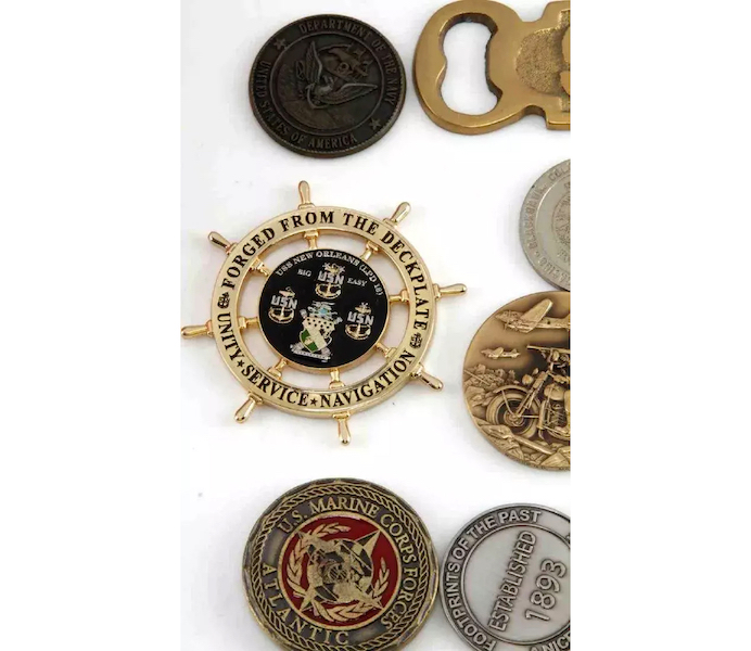 The group of more than 100 US Navy challenge coins that sold for $230 plus the buyer’s premium in October 2018 included one shaped like an old-fashioned ship’s wheel. Image courtesy of Affiliated Auctions and LiveAuctioneers.