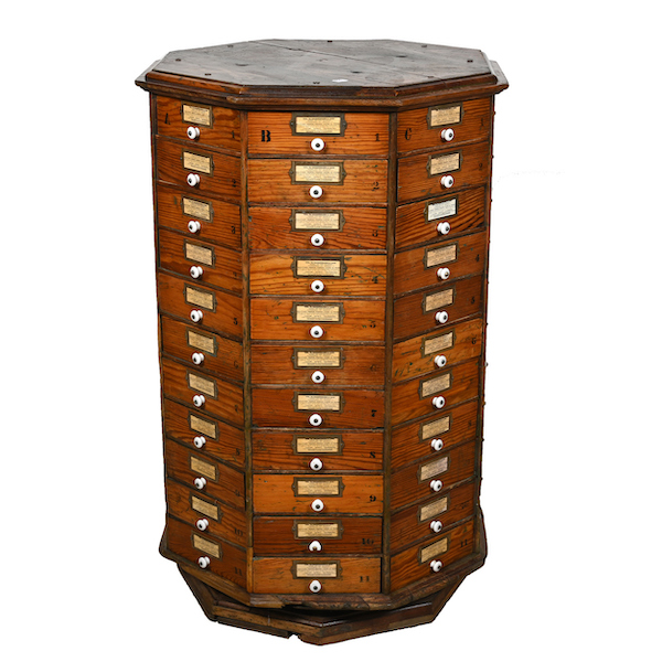 Eight-sided oak revolving hardware cabinet with 88 drawers and porcelain drawer pulls and ties to General G. A. Custer, estimated at $3,000-$5,000