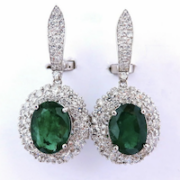 Halo cluster diamond and emerald dangle earrings, estimated at $27,000-$32,000