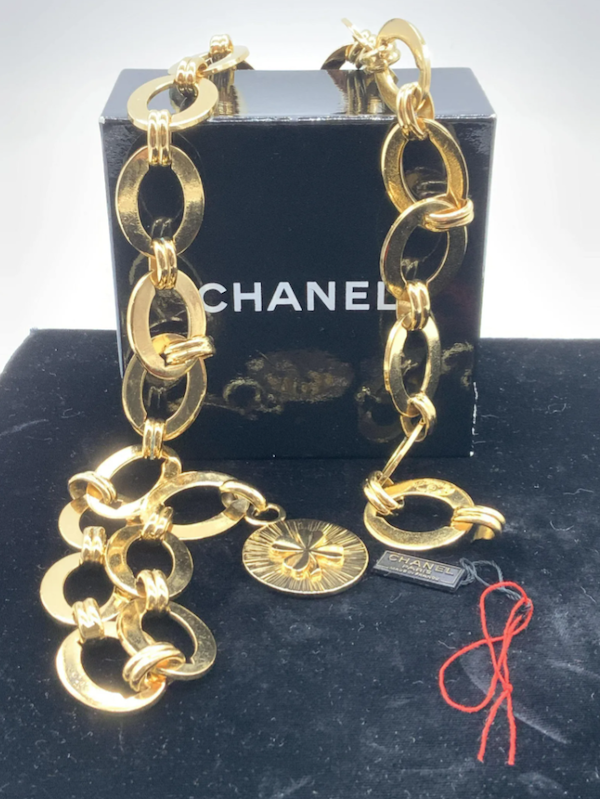 Chanel heavy gold-tone chain belt with a shamrock charm, estimated at $200-$1,000