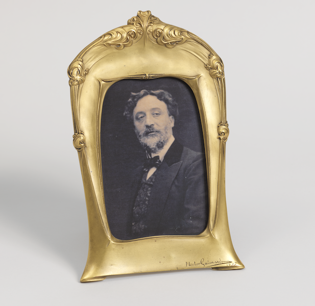 Picture frame, 1907; designed by Hector Guimard (French, 1867–1942); produced by Philippon (Paris, France). Bronze, gold, plate glass; modern photo reproduction; 24.8 by 16.5 by 16.5cm (9 3/4 by 6 1/2 by 6 1/2in.). Cooper Hewitt, Smithsonian Design Museum; gift of Mme Hector Guimard, 1948-114-4-a,b; Photo: Matt Flynn © Smithsonian Institution